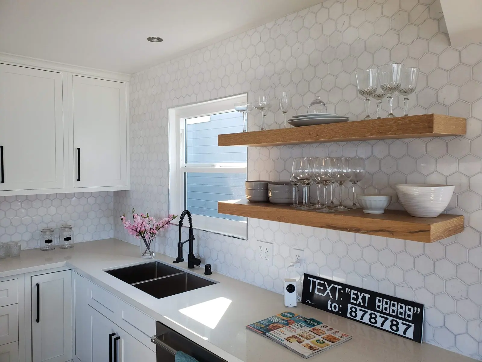 Kitchen sink wall with hexagon tile backsplash and floating wood shelves